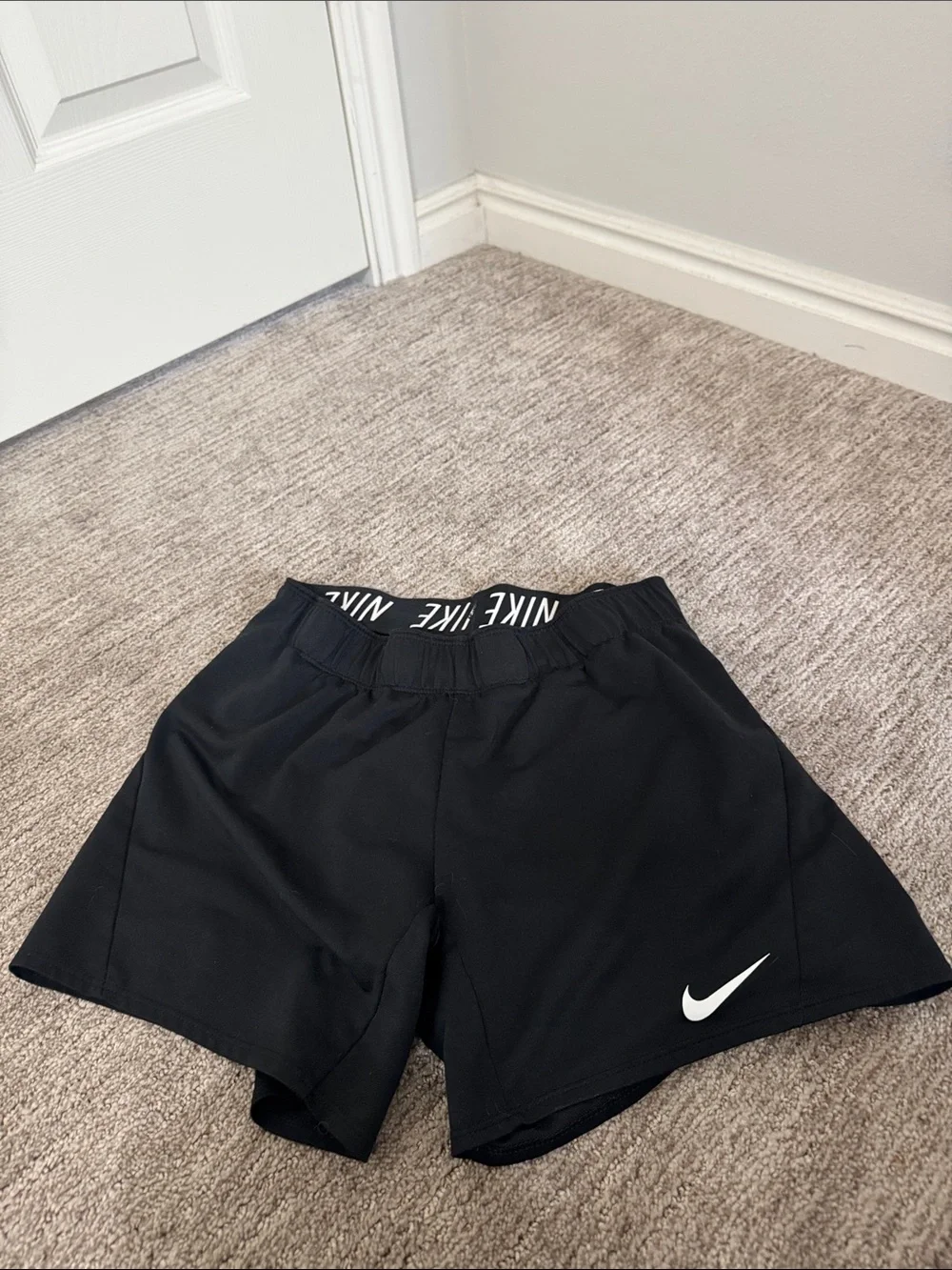 Nike Black Women's Athletic Shorts with White Swoosh and Branded Waistband